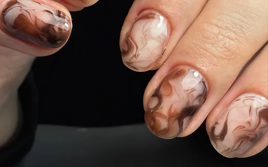 Detailed sculpted nail art with intricate design